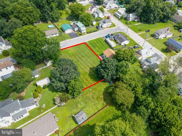 an aerial view of a tennis ground and a houses