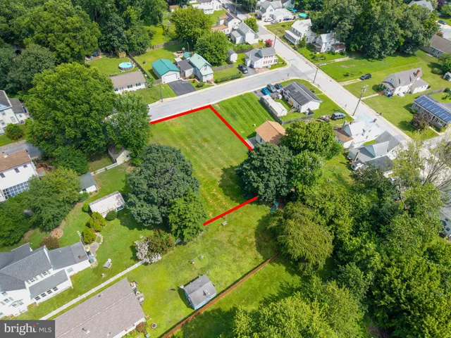 an aerial view of a tennis ground and a houses