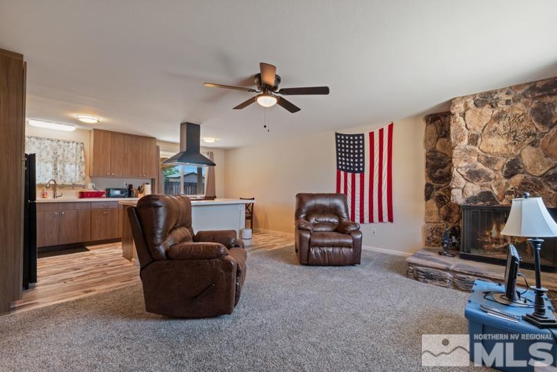 14035 Feldspar Court Reno, NV 89521 - Photo 3 of 16 a living room filled with furniture and a chandelier