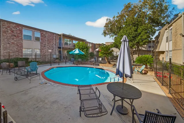 a view of a swimming pool with a patio
