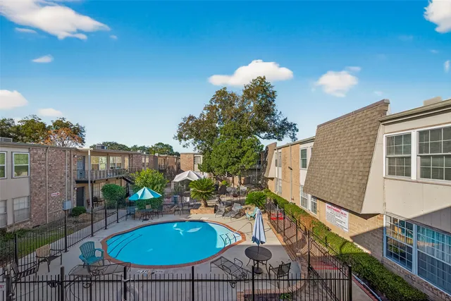 a swimming pool with outdoor seating and yard