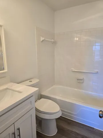 a bathroom with a sink a toilet and bathtub