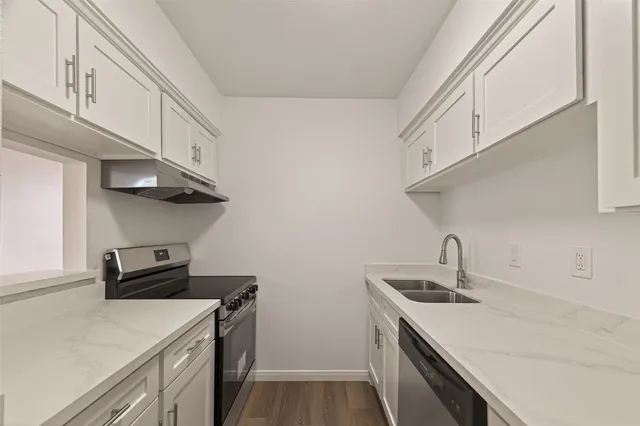 a kitchen with stainless steel appliances a sink a stove and a refrigerator