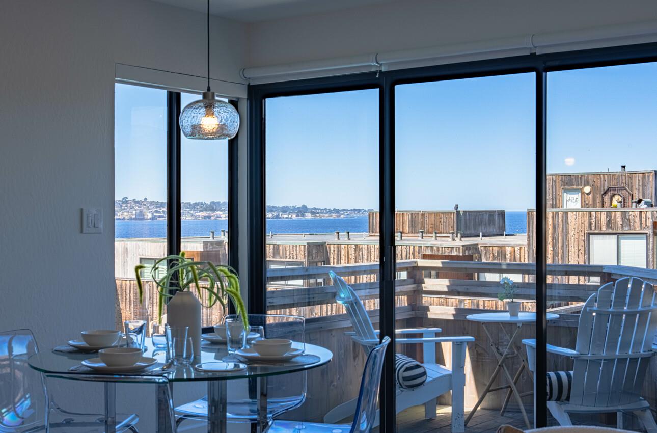 125 Surf Way, Unit 438 Monterey, CA 93940 - Photo 1 of 45 a view of a dining room with furniture window and wooden floor