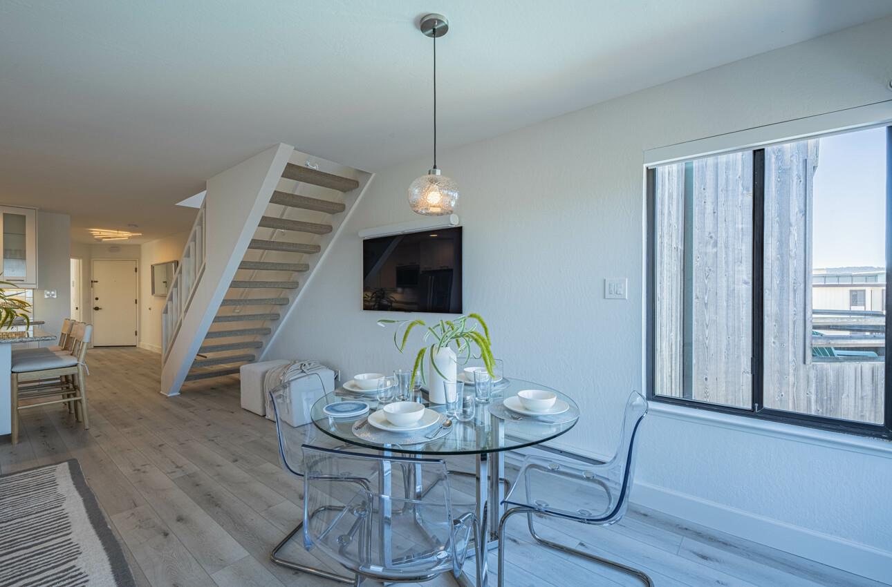 125 Surf Way, Unit 438 Monterey, CA 93940 - Photo 11 of 45 a view of a dining room with furniture window and wooden floor