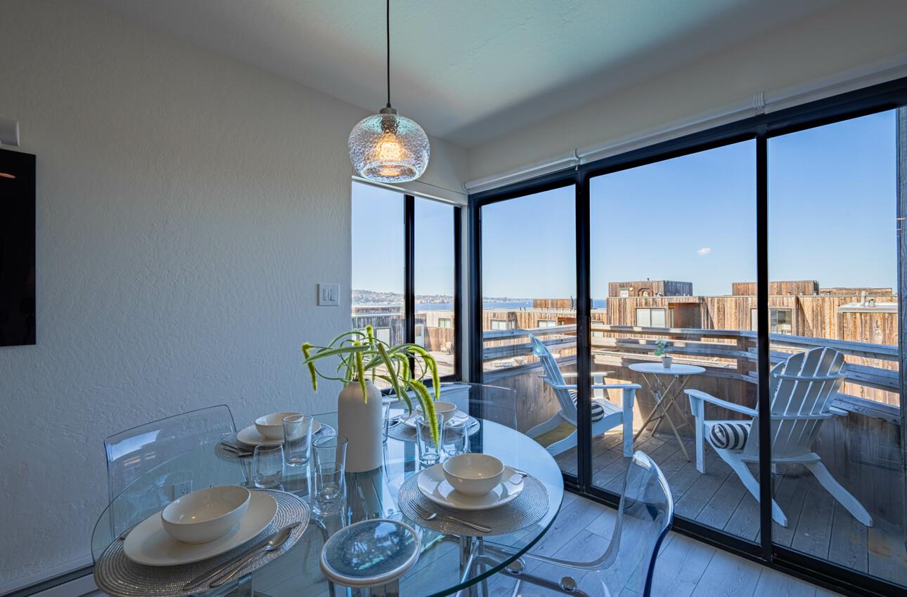 125 Surf Way, Unit 438 Monterey, CA 93940 - Photo 12 of 45 a view of a dining room with furniture window and wooden floor