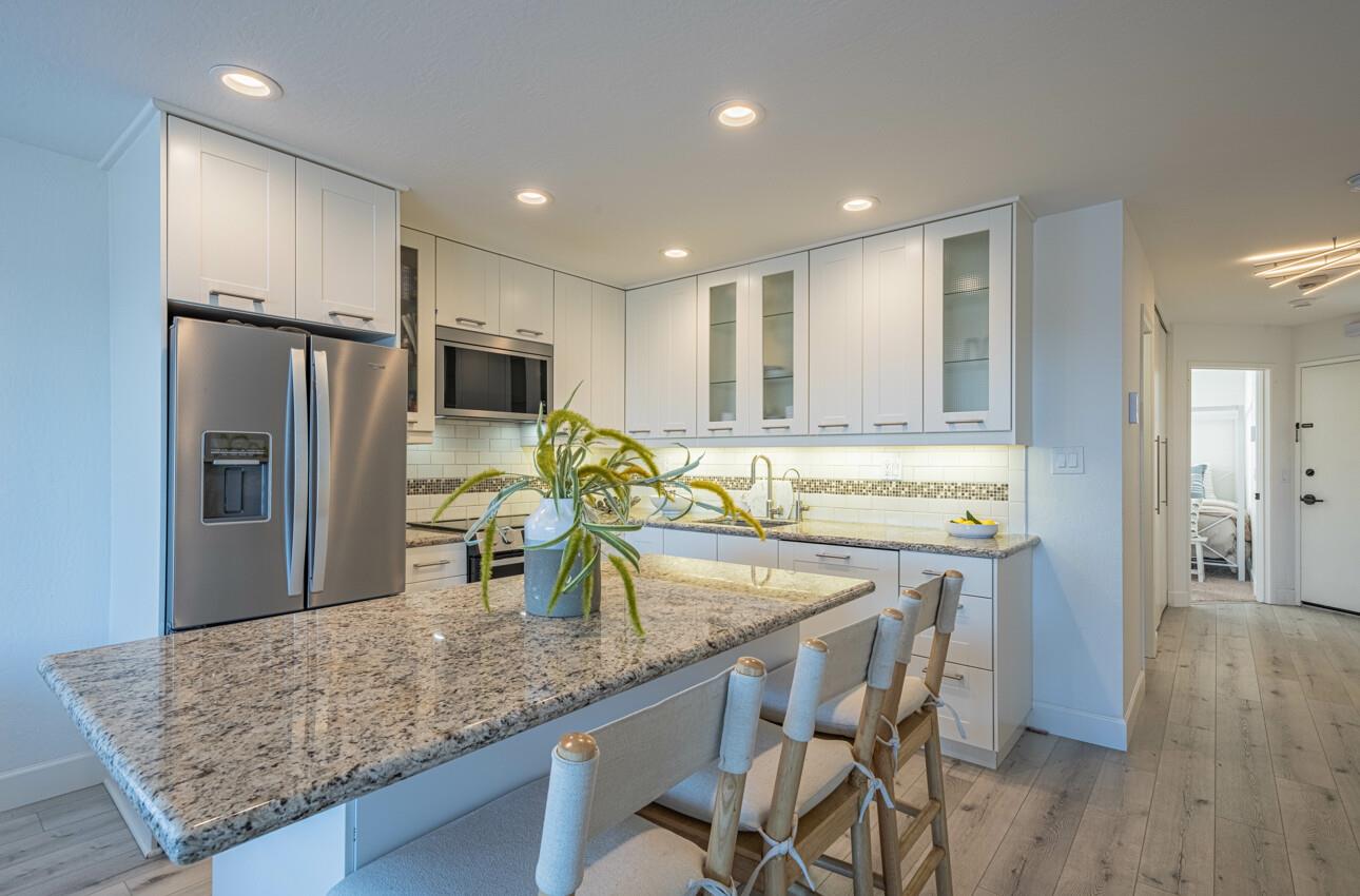 125 Surf Way, Unit 438 Monterey, CA 93940 - Photo 18 of 45 a kitchen with counter top space cabinets and stainless steel appliances