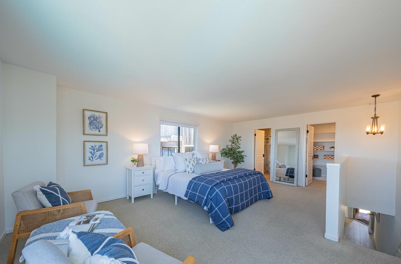 125 Surf Way, Unit 438 Monterey, CA 93940 - Photo 24 of 45 a bedroom with a bed and window