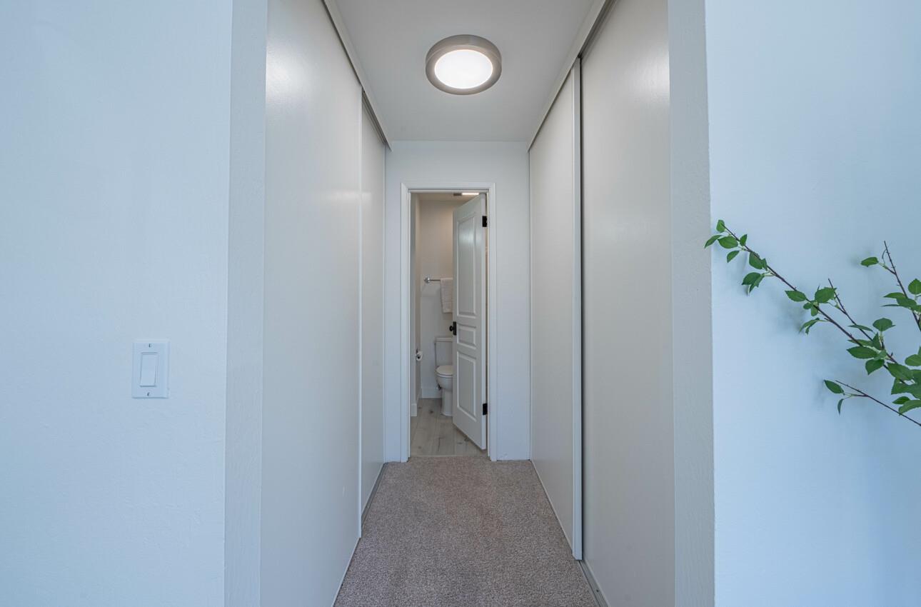 125 Surf Way, Unit 438 Monterey, CA 93940 - Photo 34 of 45 a view of a hallway with wooden door