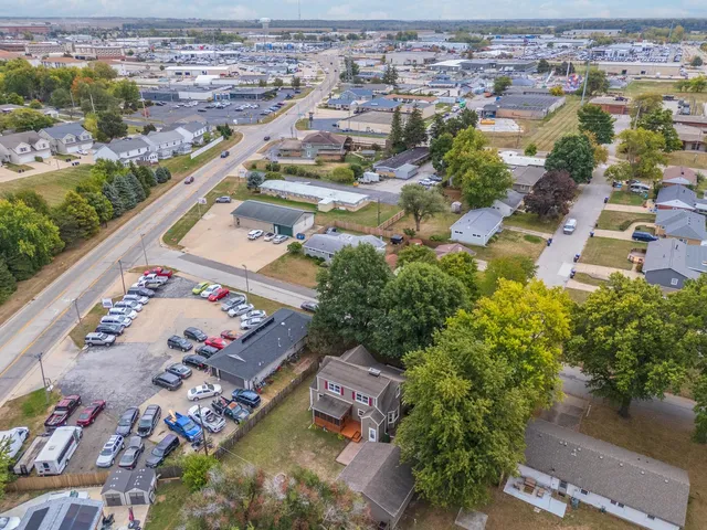 a view of a house with a large tree in front of it
