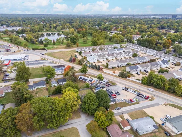 a view of a house with backyard and a tree