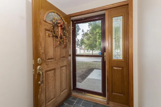 an empty room with fireplace and mirrors