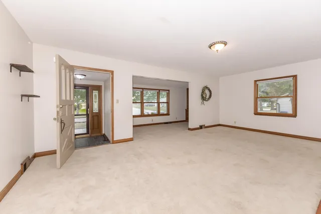 a view of a livingroom with a fireplace and window