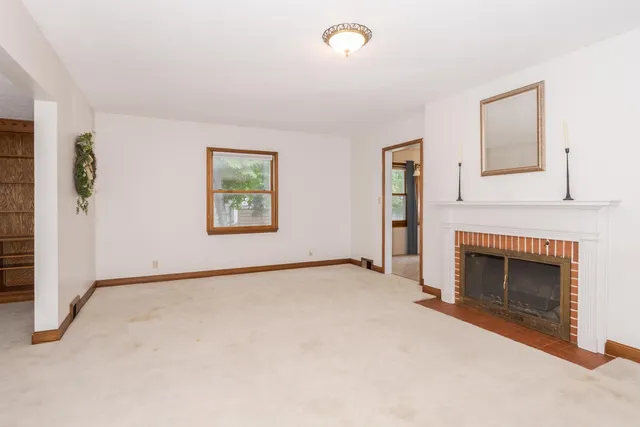 a view of empty room with a fireplace