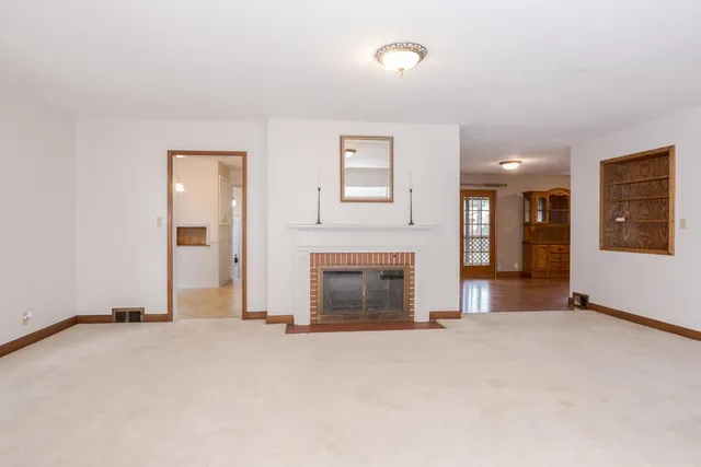 a view of kitchen with refrigerator and window