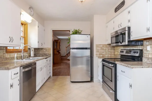 a kitchen with granite countertop a sink and a window