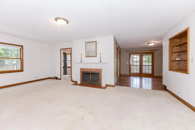 front view of a house with a large tree