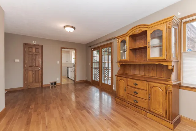 a view of an empty room with window and a ceiling fan