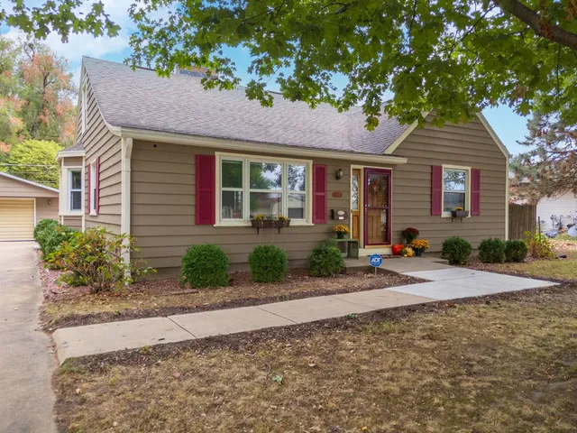 an aerial view of a house with a yard and a fountain