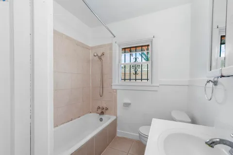 a bath room with a toilet sink and a bath tub