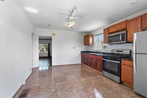 a kitchen with stainless steel appliances granite countertop a refrigerator and a stove top oven