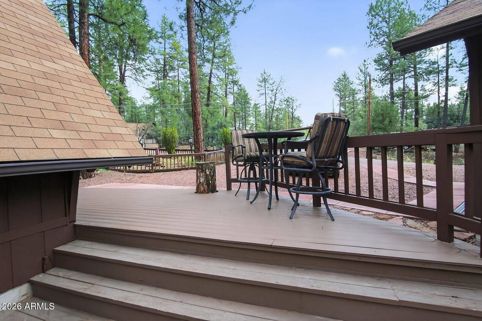 8884 Tonto Rim Drive Pine, AZ 85544 - Photo 10 of 43 a view of a patio with table and chairs with wooden floor and fence