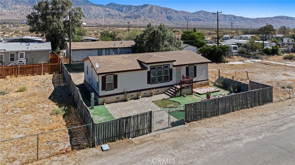 a view of a house with wooden fence