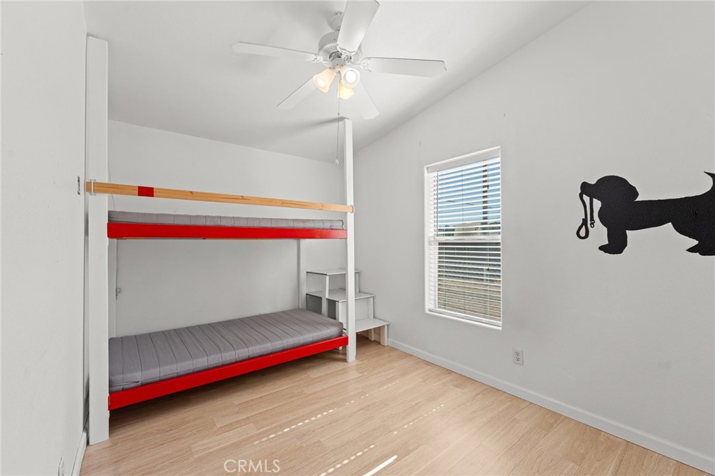 52076 Maxine Avenue Cabazon, CA 92230 - Photo 17 of 35 a bedroom with a bed and a chandelier