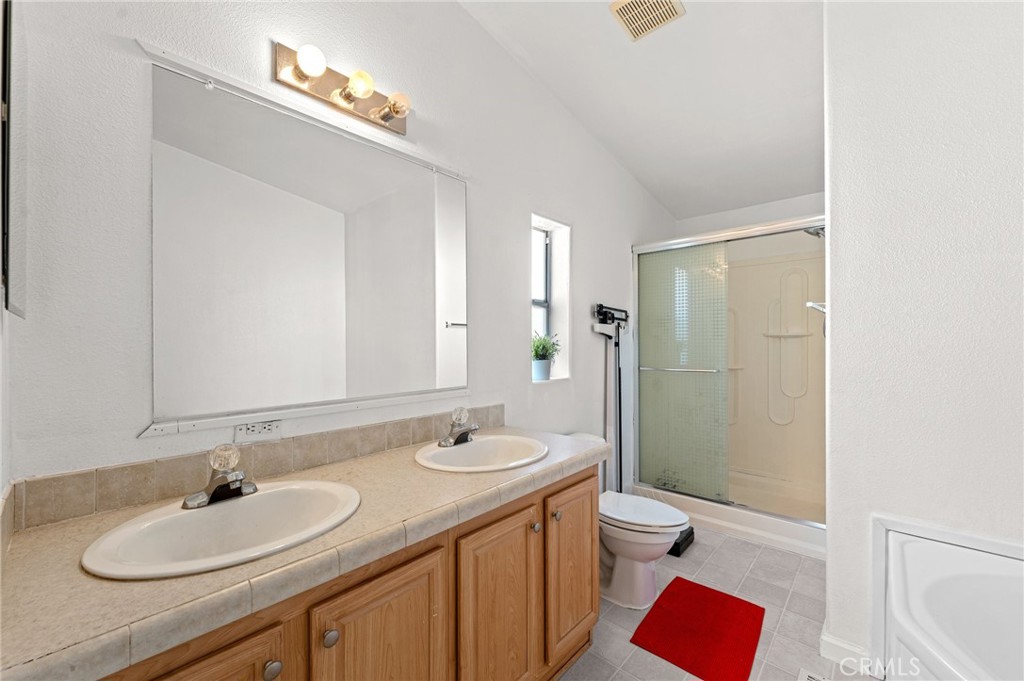 52076 Maxine Avenue Cabazon, CA 92230 - Photo 24 of 35 a bathroom with a sink a toilet and shower