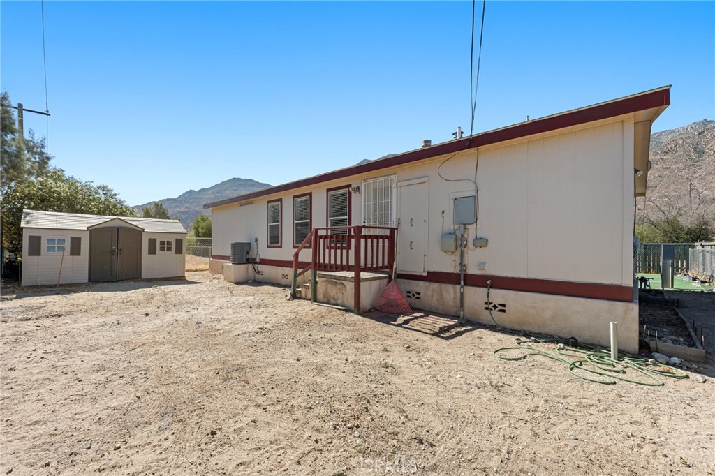 52076 Maxine Avenue Cabazon, CA 92230 - Photo 26 of 35 a backyard of a house with a yard and garage