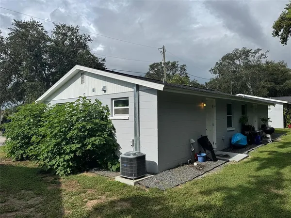 a view of a house with backyard porch and sitting area