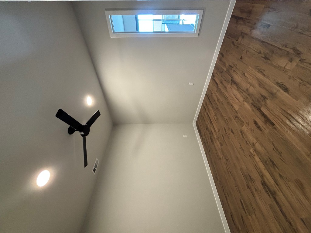 4510 Terry-O Lane, Unit 406 Austin, TX 78745 - Photo 20 of 35 an empty room with wooden floor and windows