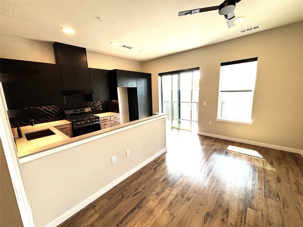 4510 Terry-O Lane, Unit 406 Austin, TX 78745 - Photo 7 of 35 a view of a kitchen with furniture and wooden floor