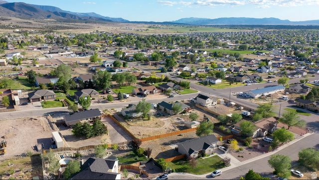 1797 Sunset Road Enoch, UT 84721 - Photo 69 of 80 Expansive lot featuring a natural landscape and partial fencing, set within a developed residential area