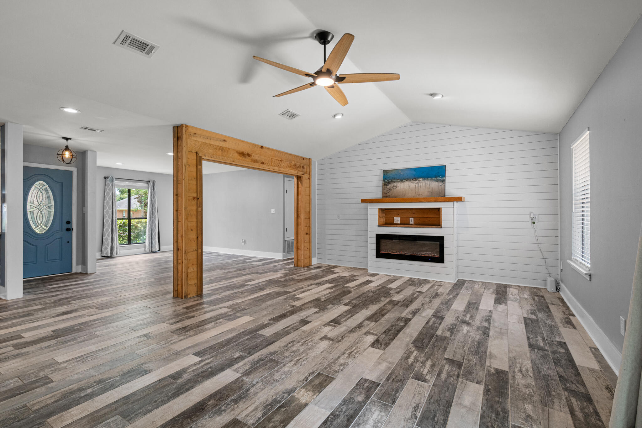 8573 Westview Lane Pensacola, FL 32514 - Photo 11 of 35 a view of a livingroom with a fireplace a ceiling fan and wooden floor