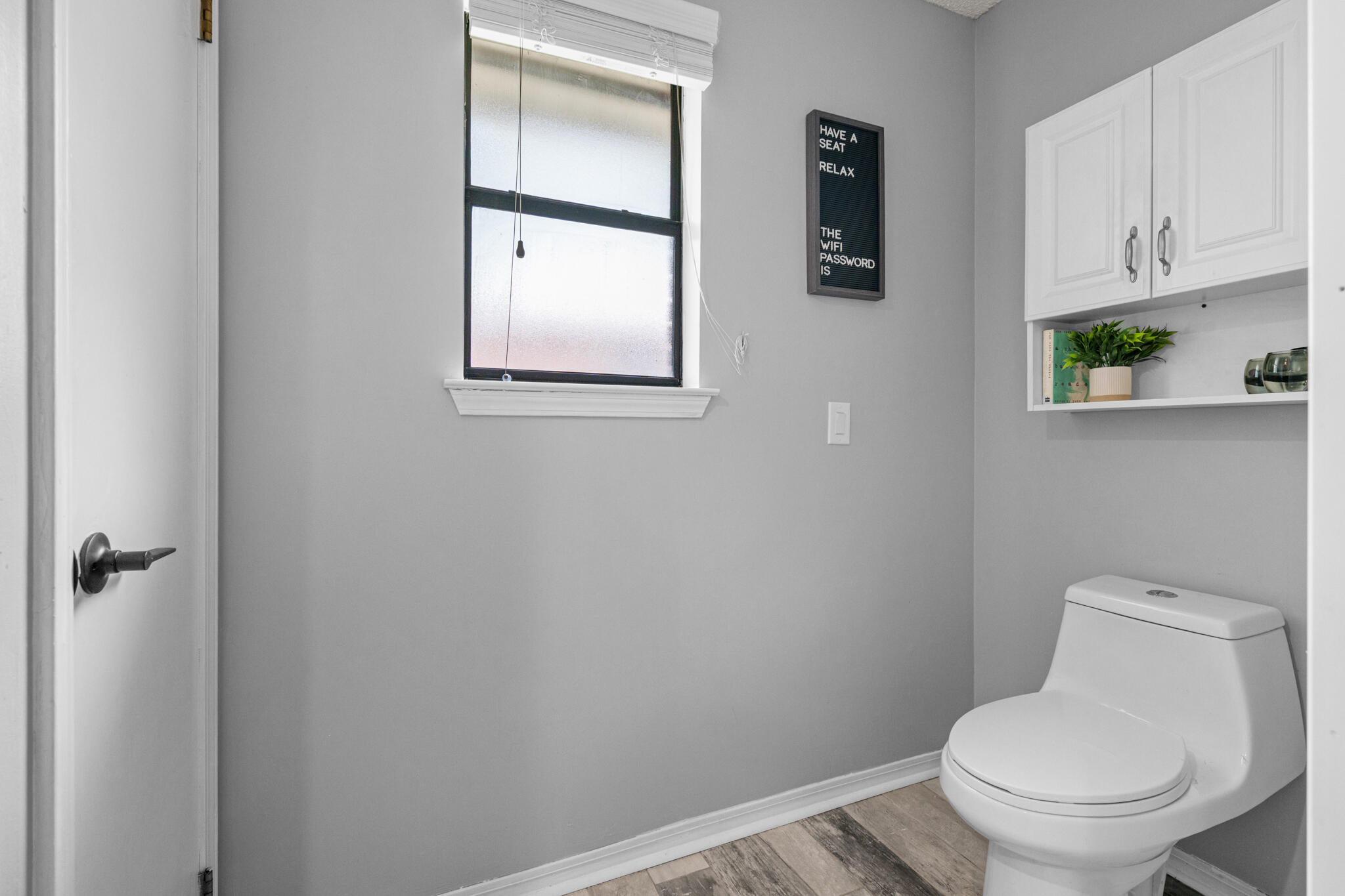 8573 Westview Lane Pensacola, FL 32514 - Photo 24 of 35 a white toilet sitting next to a bathroom sink