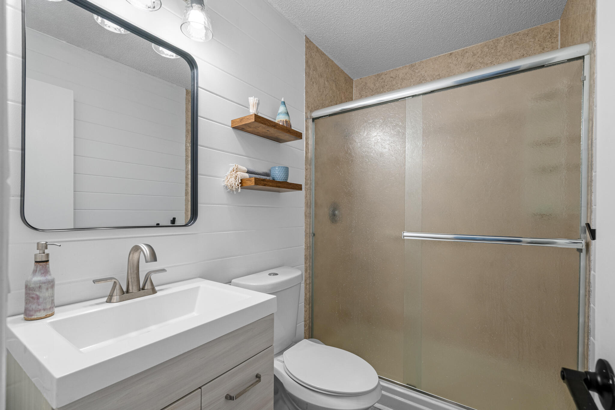 8573 Westview Lane Pensacola, FL 32514 - Photo 27 of 35 a bathroom with a sink mirror toilet and shower