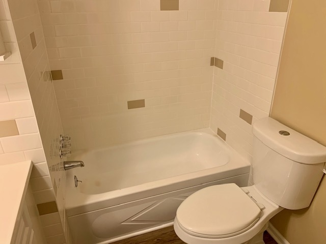 1165 Lake Terrace Road Elgin, IL 60123 - Photo 9 of 14 a white toilet and tub sitting next to a shower