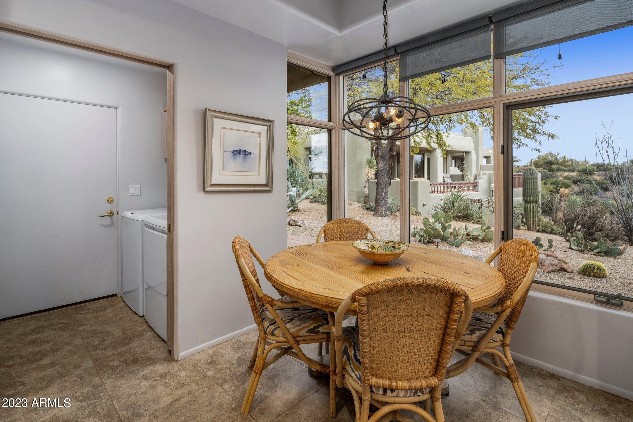 10111 East Graythorn Drive Scottsdale, AZ 85262 - Photo 12 of 14 a view of a dining room with furniture window and outside view