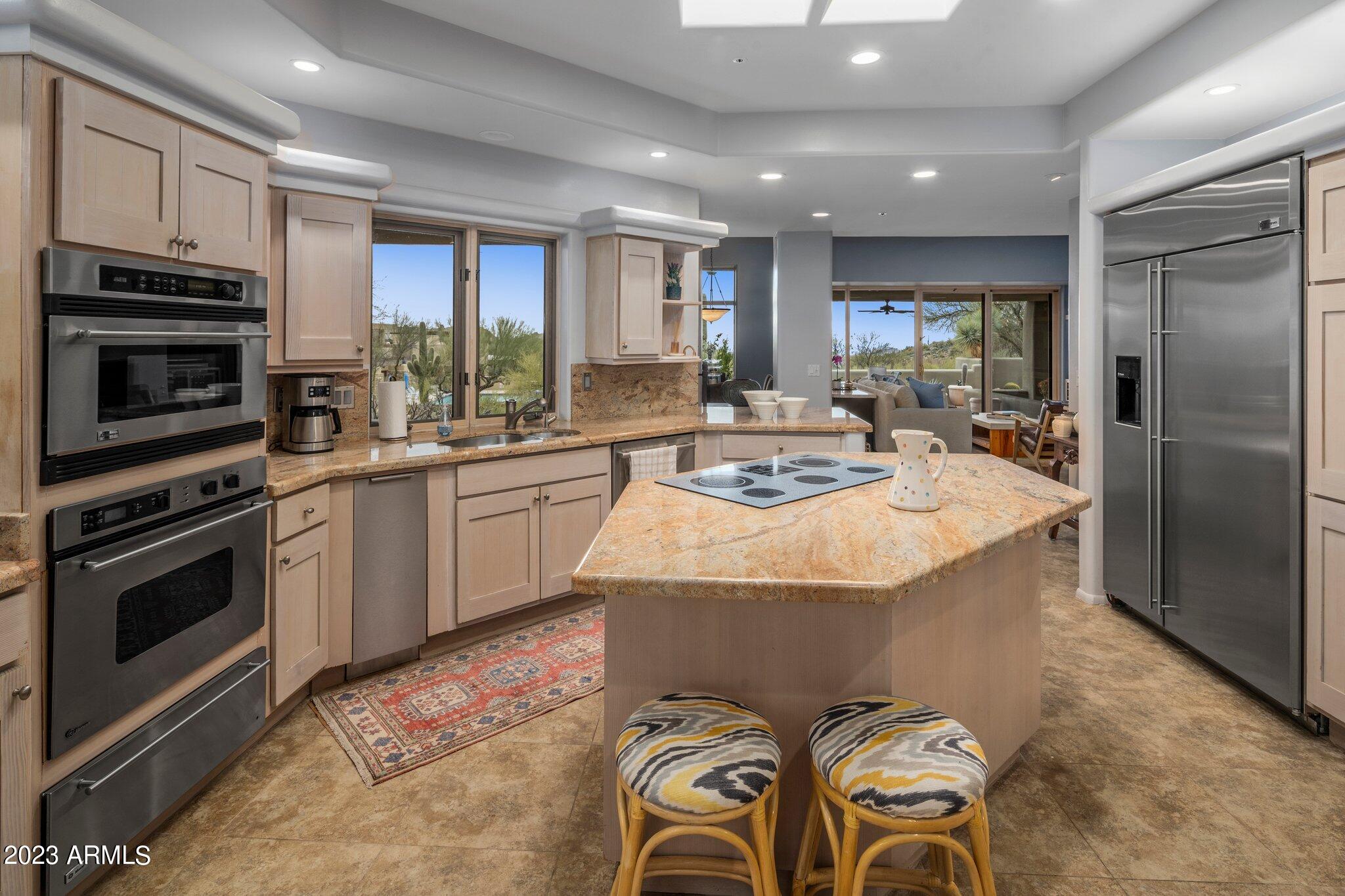 10111 East Graythorn Drive Scottsdale, AZ 85262 - Photo 13 of 14 a kitchen with sink refrigerator and stove