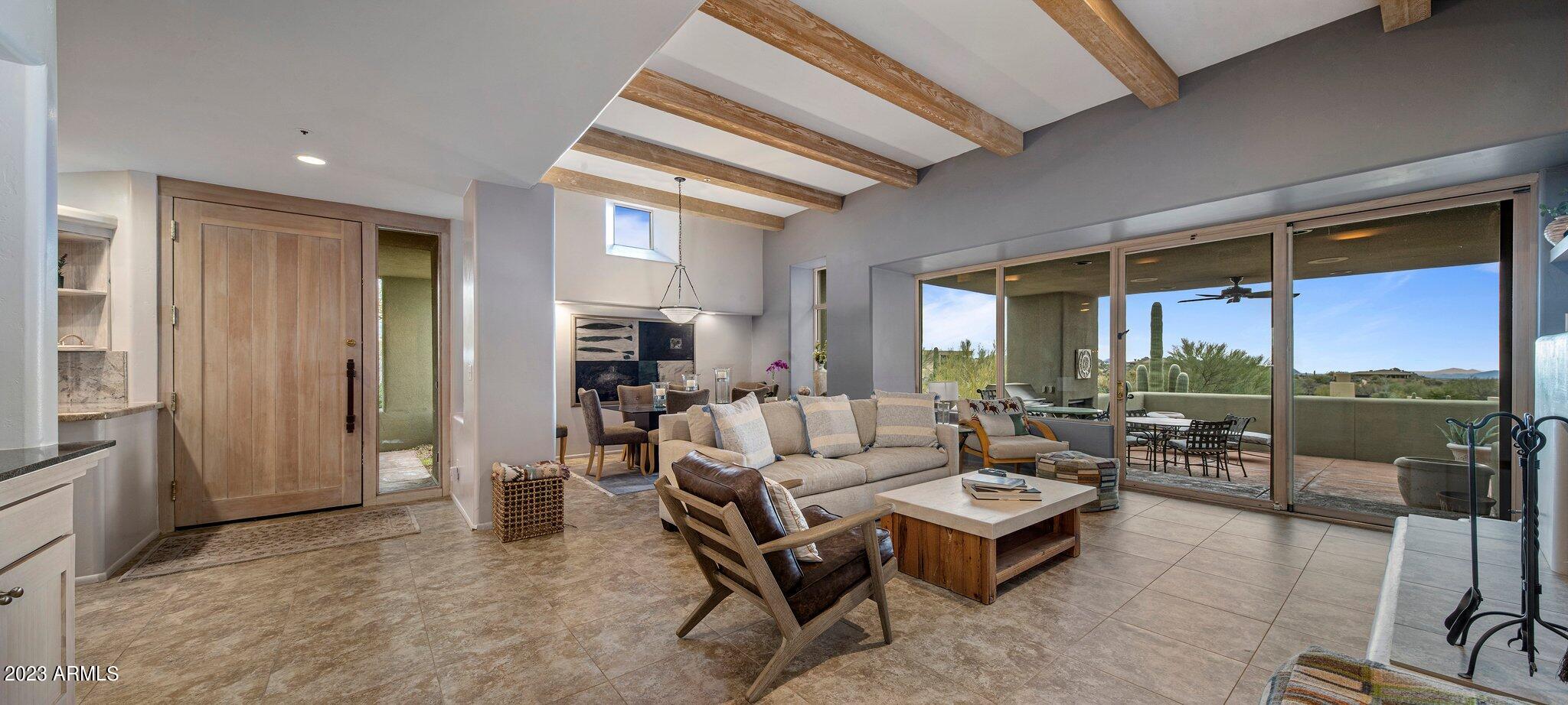 10111 East Graythorn Drive Scottsdale, AZ 85262 - Photo 14 of 14 a living room with fireplace furniture and a large window
