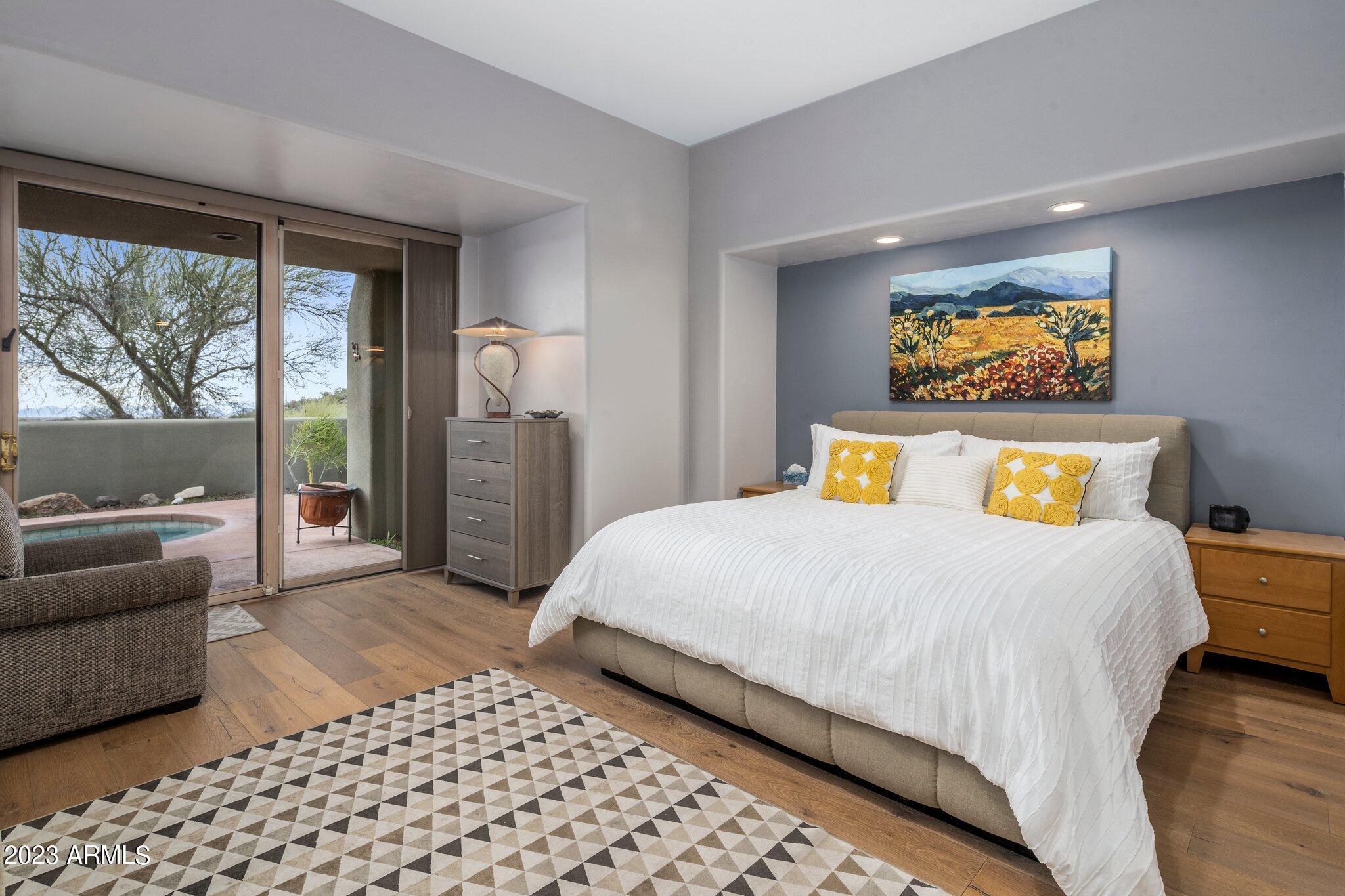 10111 East Graythorn Drive Scottsdale, AZ 85262 - Photo 2 of 14 a bedroom with a bed and glass window