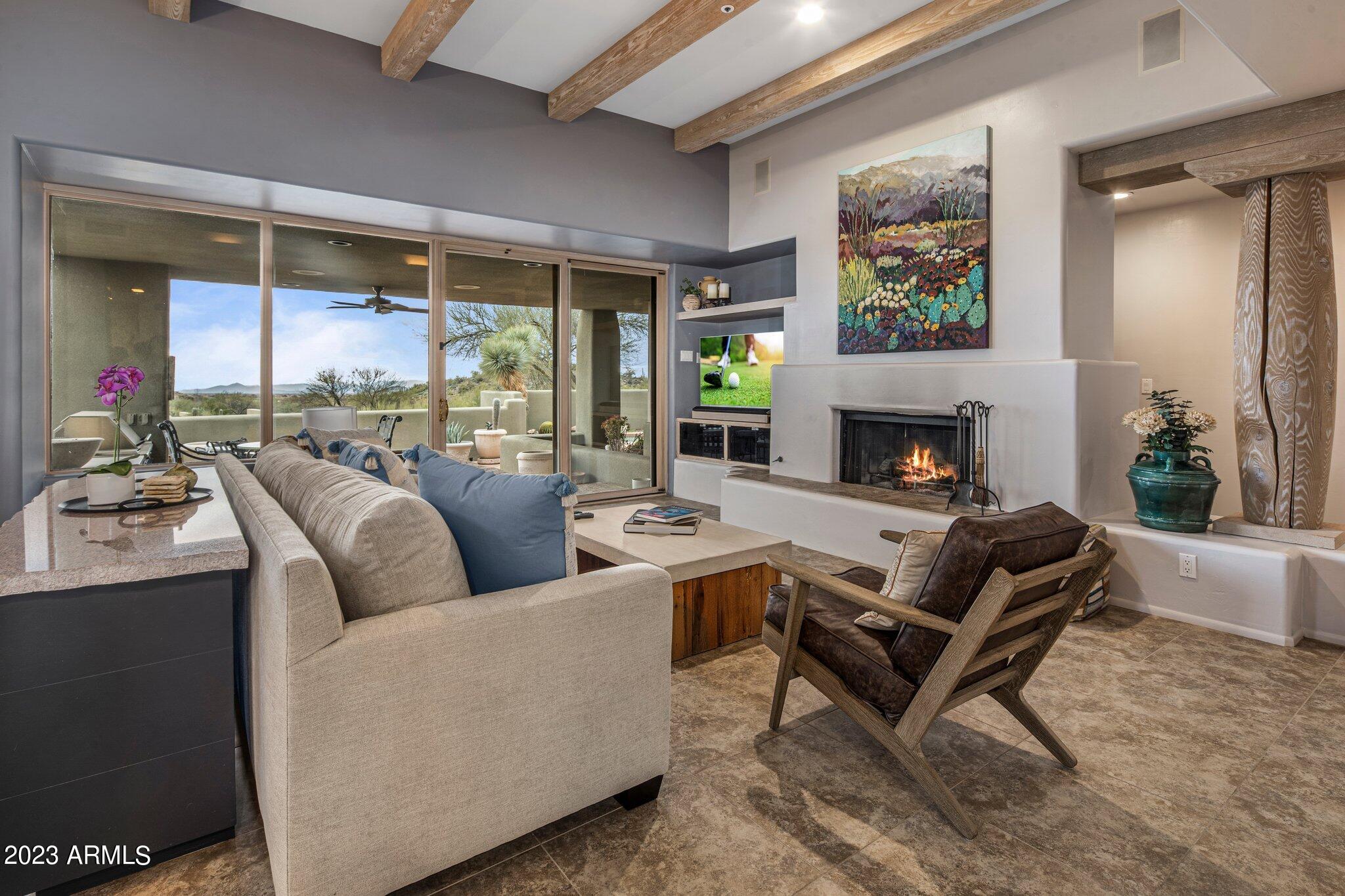 10111 East Graythorn Drive Scottsdale, AZ 85262 - Photo 3 of 14 a living room with furniture and a fireplace