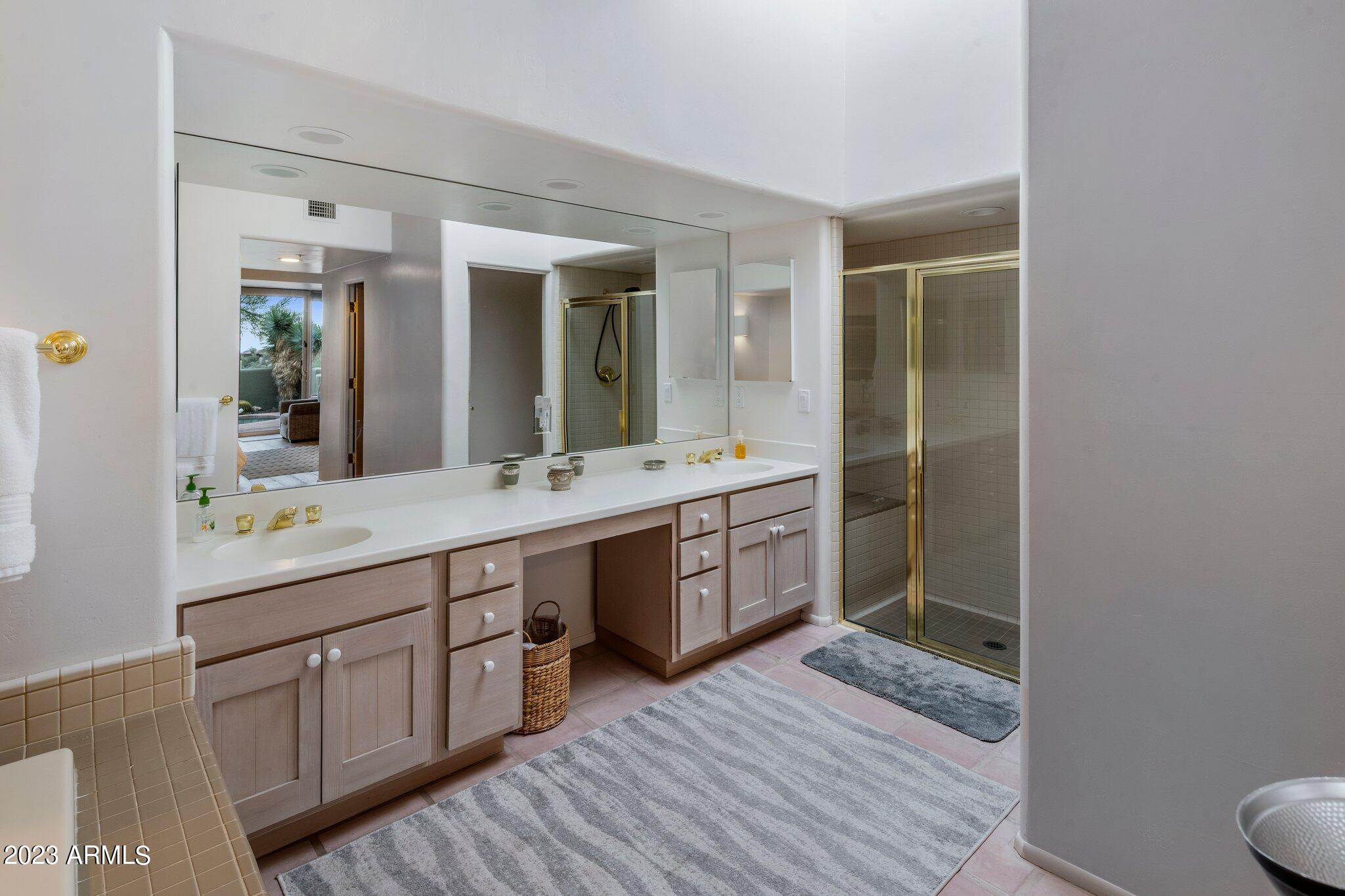 10111 East Graythorn Drive Scottsdale, AZ 85262 - Photo 10 of 14 a bathroom with a double vanity sink and a mirror