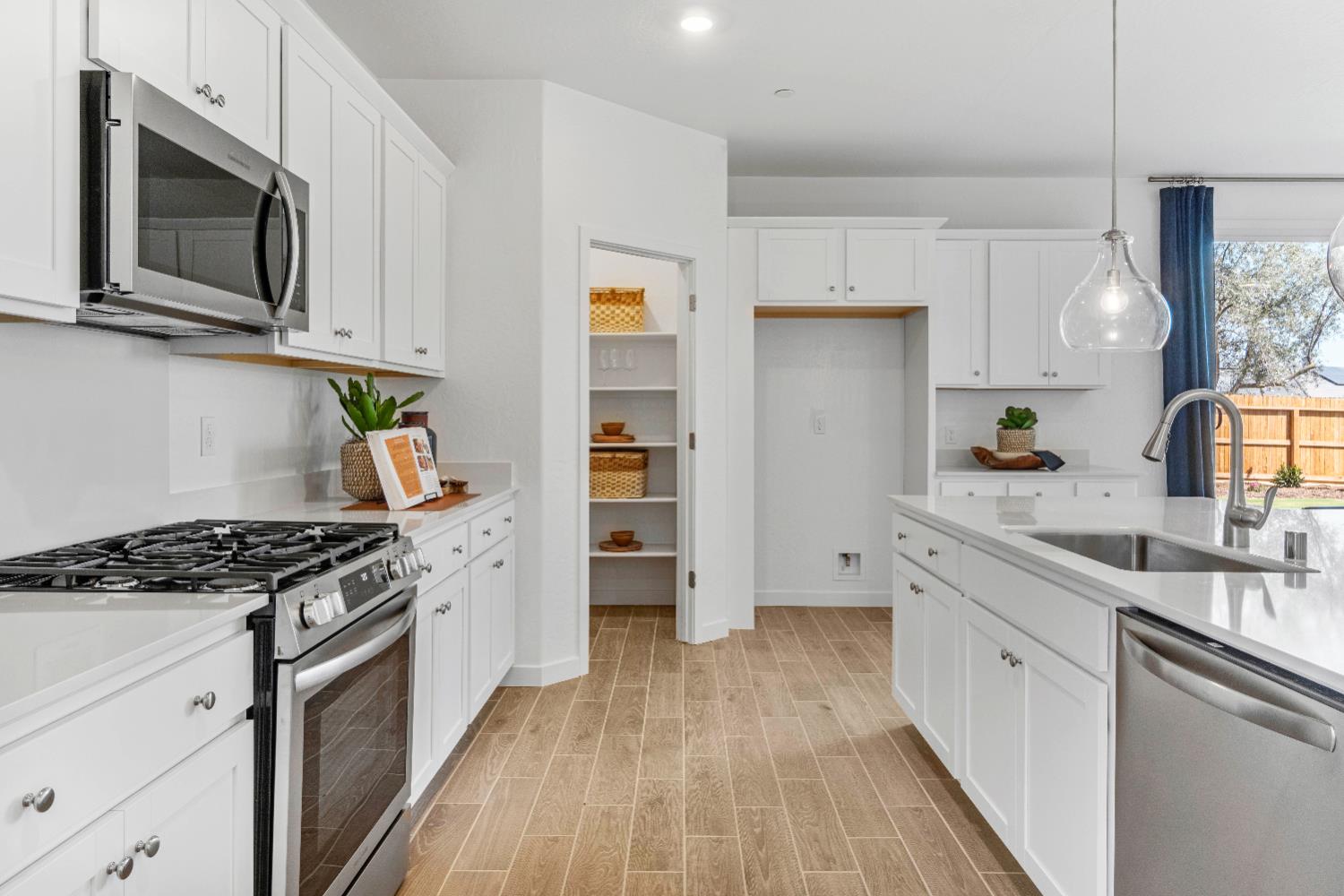 822 Traverse Drive Madera, CA 93636 - Photo 19 of 40 a kitchen with stainless steel appliances a white stove top oven a sink dishwasher and a refrigerator