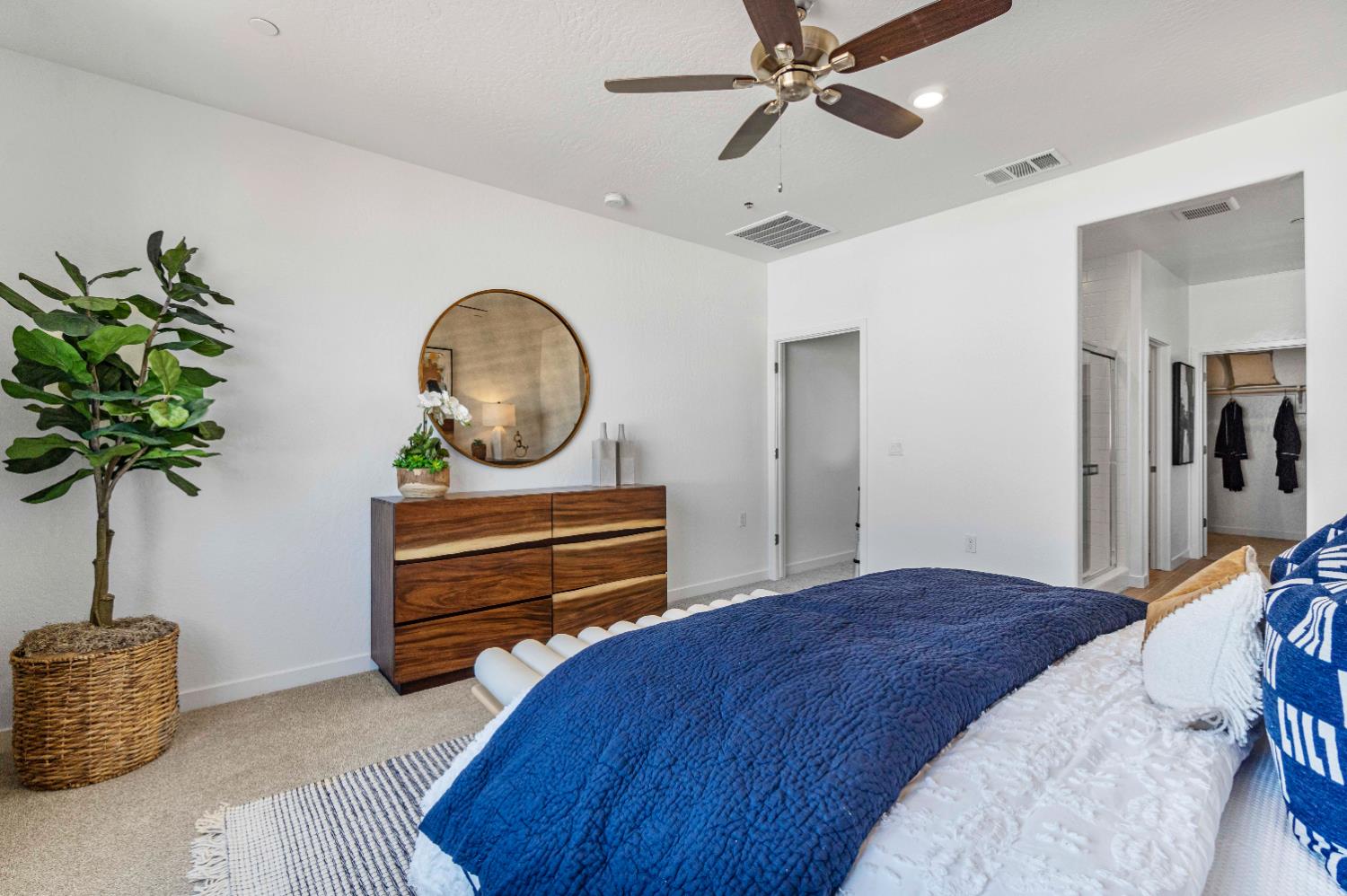 822 Traverse Drive Madera, CA 93636 - Photo 36 of 40 a bedroom with a bed and a potted plant