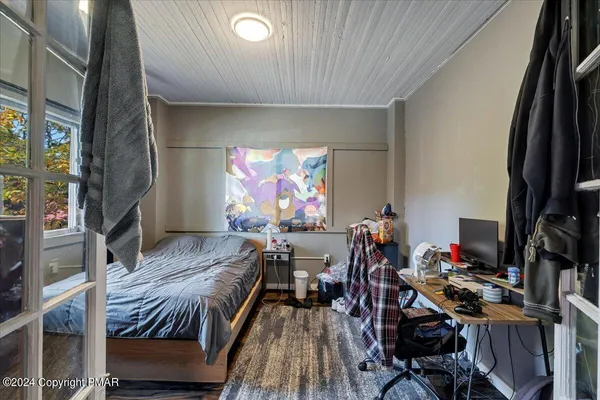 a bedroom with furniture and a window
