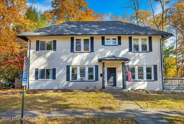a front view of a house with a swimming pool