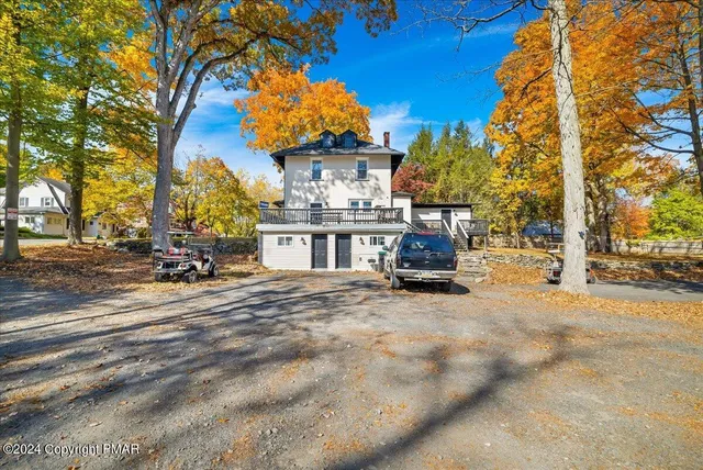 a front view of a house with a yard patio and swimming pool