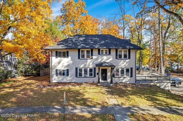 a front view of a house with a garden